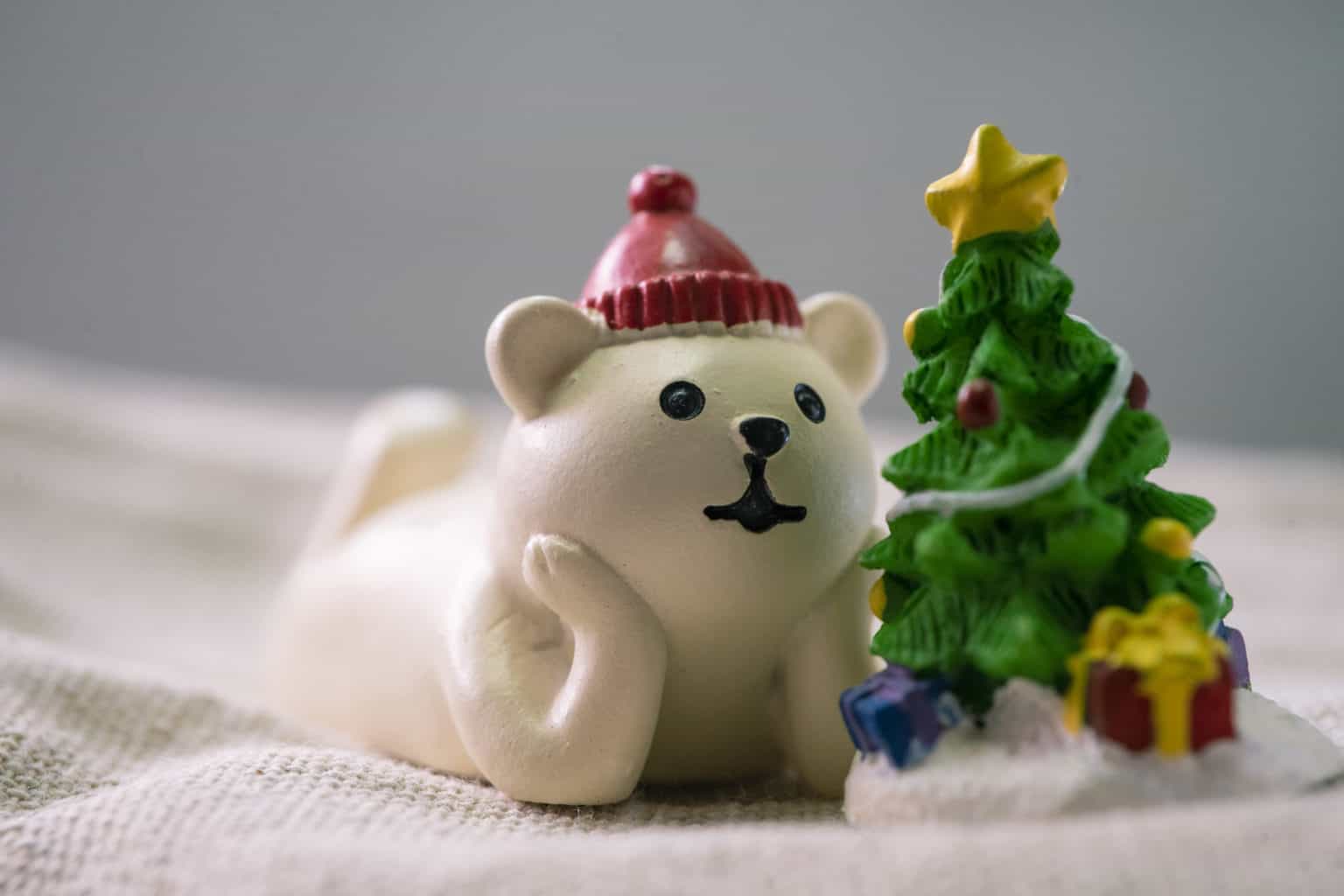 white polar bear beside christmas tree figurines 