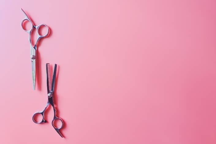 Cutting shears in light pink background