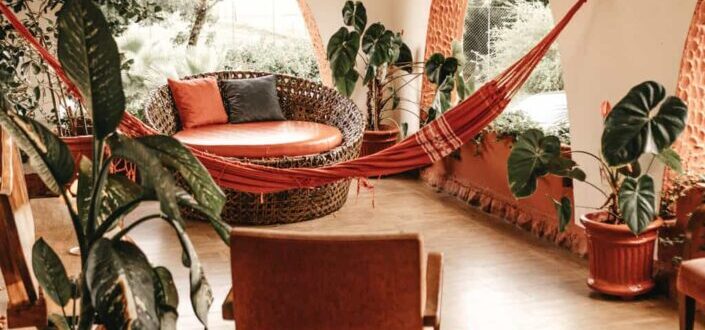 Red hammock hanging in the middle of a room