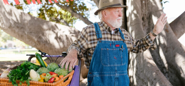 An elderly man selling vegetables