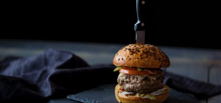 burger skewered with knife