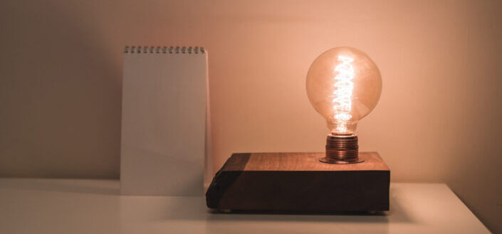 Table with lightbulb and notepad