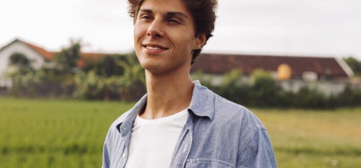 Young Man in Blue Shirt on a Field