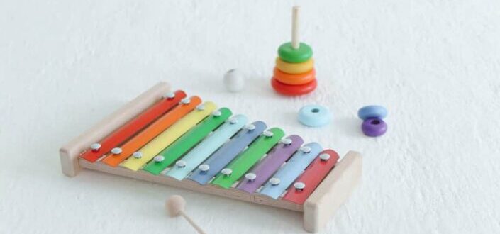 A xylophone and ring toss on white surface